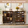 Two wooden shoe cabinets with golden legs are shown side-by-side, filled with shoes and boots. Decorative items like flowers and framed pictures are on top of the cabinets. Náhľad obrázku produktu