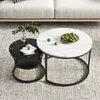 Two round coffee tables with marble patterns are placed on a rug in front of a sofa. Produktbild-Vorschau