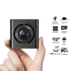 A hand holding a small black dashcam with various feature icons and text displayed to its right. Náhled obrázku produktu