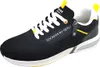 A single black sneaker with white laces and yellow accents is shown against a white background. Voir les images du produit