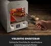 A hand is shown removing a steak from a high-temperature grill. Produktbild-Vorschau