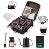 A collection of coffee brewing equipment laid out, including a travel case. Voir les images du produit