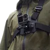 A person wearing a green jacket with a chest mount and action camera attached. Anteprima dell’immagine prodotto
