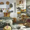A child's bedroom decorated with a jungle theme, featuring bedding, pillows, rugs, and wall decor. Náhled obrázku produktu
