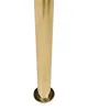 A close-up of a golden metal leg of a chair or table. Náhled obrázku produktu