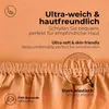Close-up of a peach-colored fabric with text overlays highlighting product features. Náhľad obrázku produktu