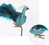 A decorative peacock ornament with a clip attached, shown against a white background. Produktbild-Vorschau