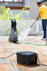 A man is using a pressure washer on a patio, with a black box in the foreground. Anteprima dell’immagine prodotto
