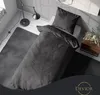 A bedroom scene with a bed, rug, and lamp. Produktbild-Vorschau