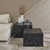 Two square coffee tables with a marble look are placed next to a sofa in a room with a patterned wall. Anteprima dell’immagine prodotto