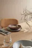 A table setting with plates, cutlery, glasses, and a decorative element. Produktbild-Vorschau