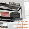 A black metal shelving unit with various items stored on its shelves, including a vintage suitcase, a toolbox, and tires. The image also features promotional text overlays. Produktbild-Vorschau