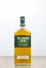 A bottle of Tullamore D.E.W. Irish Whiskey is centered on a wooden surface against a white background. Produktbild-Vorschau