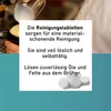 A close-up of someone pouring milk into a coffee cup, with text overlays describing cleaning tablets, and an image of the tablets at the bottom. Produktbild-Vorschau