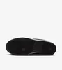 The bottom view of a black sneaker with a white sole. Anteprima dell’immagine prodotto