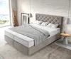 A bedroom scene with a large bed, a window overlooking the sea, and decorative elements. Produktbild-Vorschau