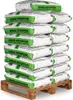 A stack of white bags with green labels, labeled 'ANMAG EKOGRYSIK', are neatly stacked on a wooden pallet. Produktbild-Vorschau