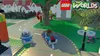 A scene from the video game LEGO Worlds, showing two LEGO cars driving on a road in a LEGO town. Produktbild-Vorschau