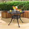 An outdoor table set on a wooden deck with greenery and stone wall in the background. Produktbild-Vorschau