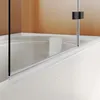 A close-up view of a bathtub with a glass shower enclosure. Produktbild-Vorschau