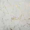 A close-up of a white blanket with a gold marbled pattern. Anteprima dell’immagine prodotto
