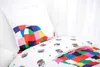A close-up view of a child's bedding set, featuring a pillow and duvet cover with a colorful elephant design. Produktbild-Vorschau