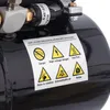 A close-up of a black air compressor tank with a sticker displaying various warning symbols and text. Podgląd zdjęcia produktu