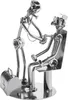 A metal sculpture of a doctor examining a patient. Anteprima dell’immagine prodotto