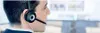 A man wearing a headset in an office environment. Produktbild-Vorschau