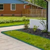 A garden scene with concrete pathways and a lawn, bordered by green plastic edging. Voir les images du produit