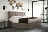 A bedroom with a large bed, a world map on the wall, and a window overlooking a balcony. Voir les images du produit