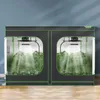 Two grow tents are shown side-by-side, each containing lush green plants illuminated by grow lights. Voir les images du produit