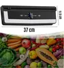 A vacuum sealer machine is shown above a colorful arrangement of fresh fruits and vegetables. Podgląd zdjęcia produktu