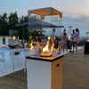 People gathered around a modern gas patio heater on a deck at dusk. Produktbild-Vorschau