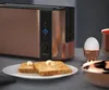 A copper toaster with two slices of toast on a plate, an egg in an egg cup, and a copper bowl. Náhľad obrázku produktu