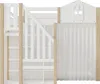 A close-up view of a white and natural wood bunk bed with stairs and a white curtain. Produktbild-Vorschau