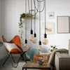 A living room scene with a cluster of pendant lights hanging over a coffee table. Produktbild-Vorschau