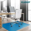 An office chair mat on a wooden floor in front of a desk with computers. Produktbild-Vorschau