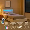 A white bed with blue LED lighting in a bedroom setting. Produktbild-Vorschau