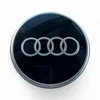 A close-up, top-down view of an Audi wheel center cap. Anteprima dell’immagine prodotto
