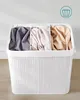 A white laundry basket with three compartments, each filled with folded laundry in different colors. Produktbild-Vorschau