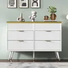 A white dresser with gold accents is displayed against a light green wall, with decorative items on top. Podgląd zdjęcia produktu