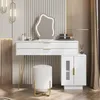 A modern white vanity table with a unique LED mirror and a matching stool, set against a textured wall. Voir les images du produit