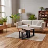 A living room scene with a couch, coffee table, plants, and a bookshelf. Náhled obrázku produktu