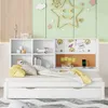 A white daybed with a bookshelf headboard, featuring decorative elements and storage compartments. Produktbild-Vorschau
