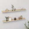 Two wooden shelves mounted on a white wall, decorated with various items. Produktbild-Vorschau