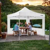 A family is enjoying a meal under a white gazebo in a backyard setting during sunset. Produktbild-Vorschau