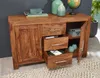 A wooden sideboard with drawers and doors open, displaying various items on top and inside, set in a room with a dark gray wall and a patterned rug. Produktbild-Vorschau
