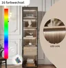 A tall, narrow cabinet with glass doors and internal lighting, showcasing decorative items and a remote control for the lights. Voir les images du produit