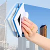 Weiß-blauer magnetischer Fensterreiniger, von einer Hand gehalten, vor einer Stadtsilhouette Náhľad obrázku produktu